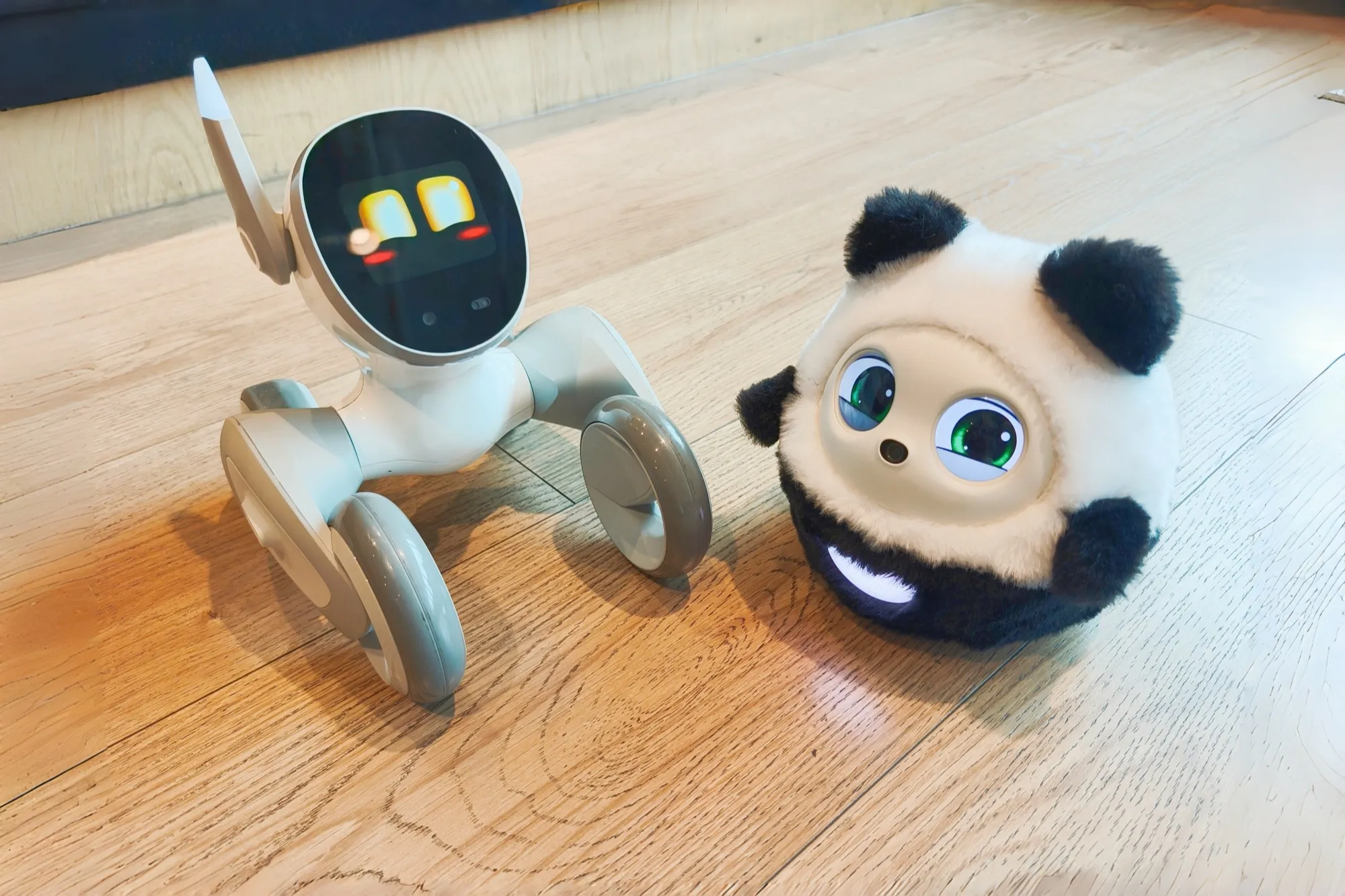 Pophie the desktop AI companion beside a roaming robot pet