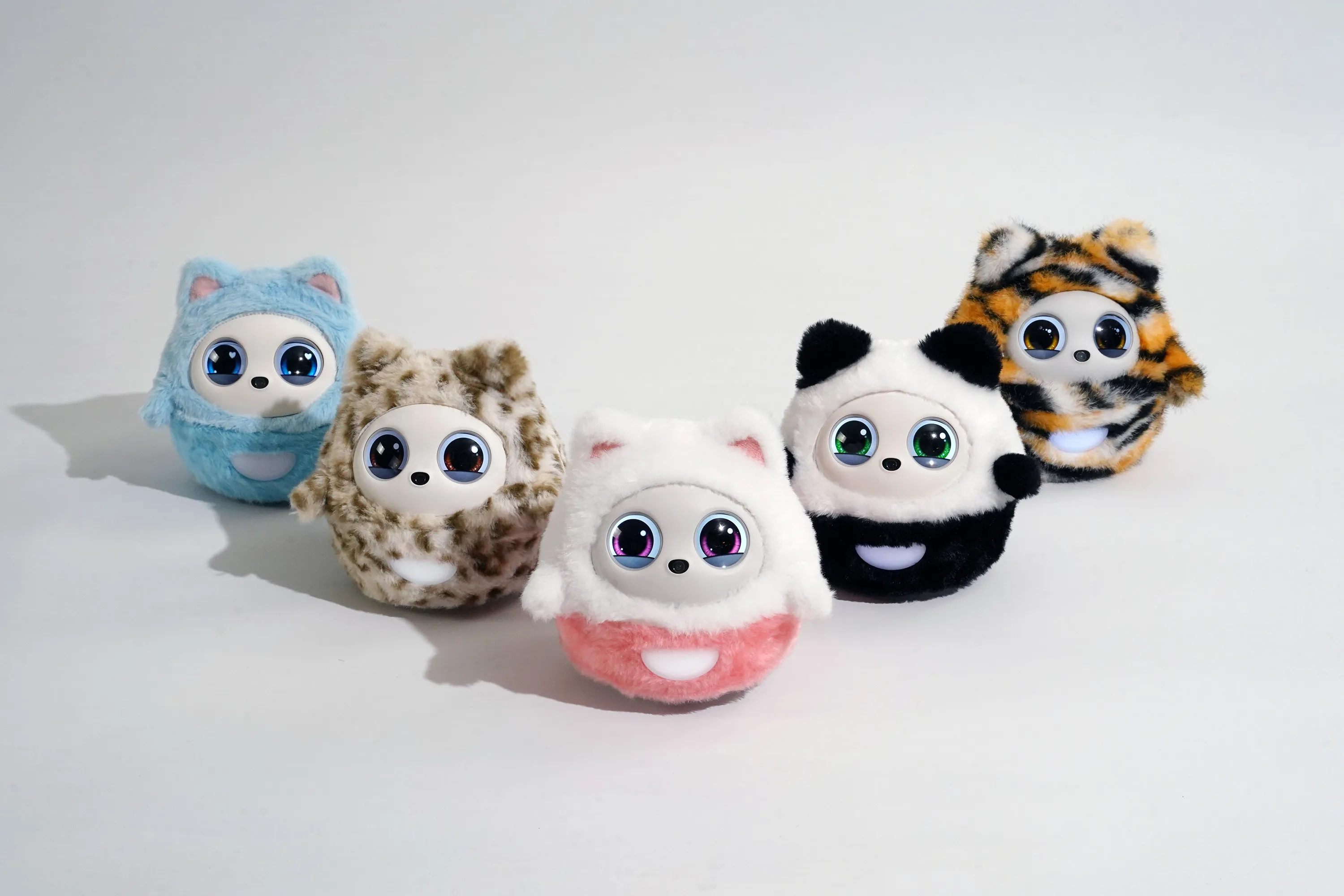 Close-up of Pophie's soft fabric exterior and expressive LCD eyes on a desk